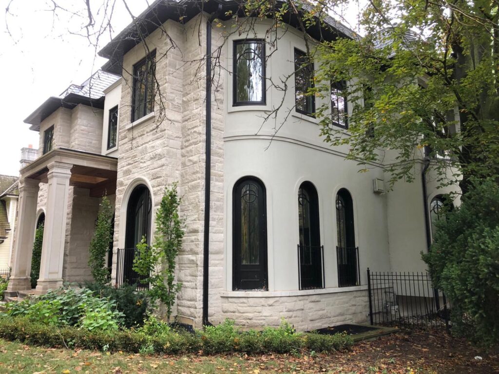 Stucco repair contractor fixing cracks on damaged exterior wall