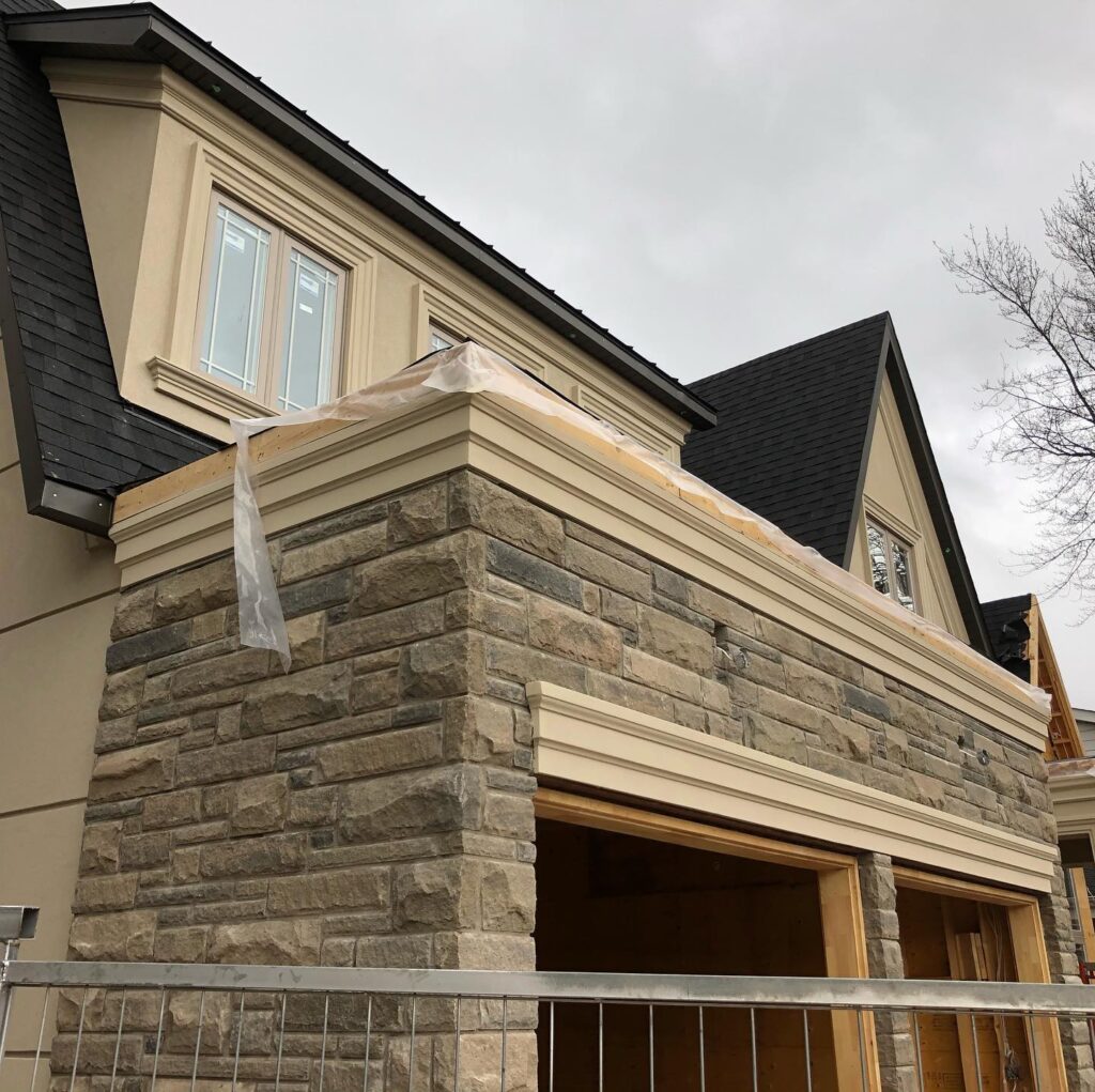 Residential stucco installation on modern home exterior with EIFS system