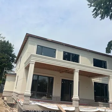 Stucco work in progress — base coat and mesh stage