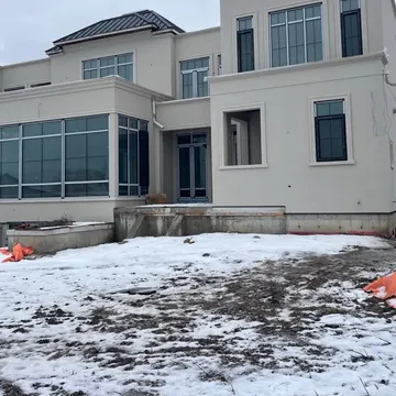 Stucco work in progress — base coat and mesh stage